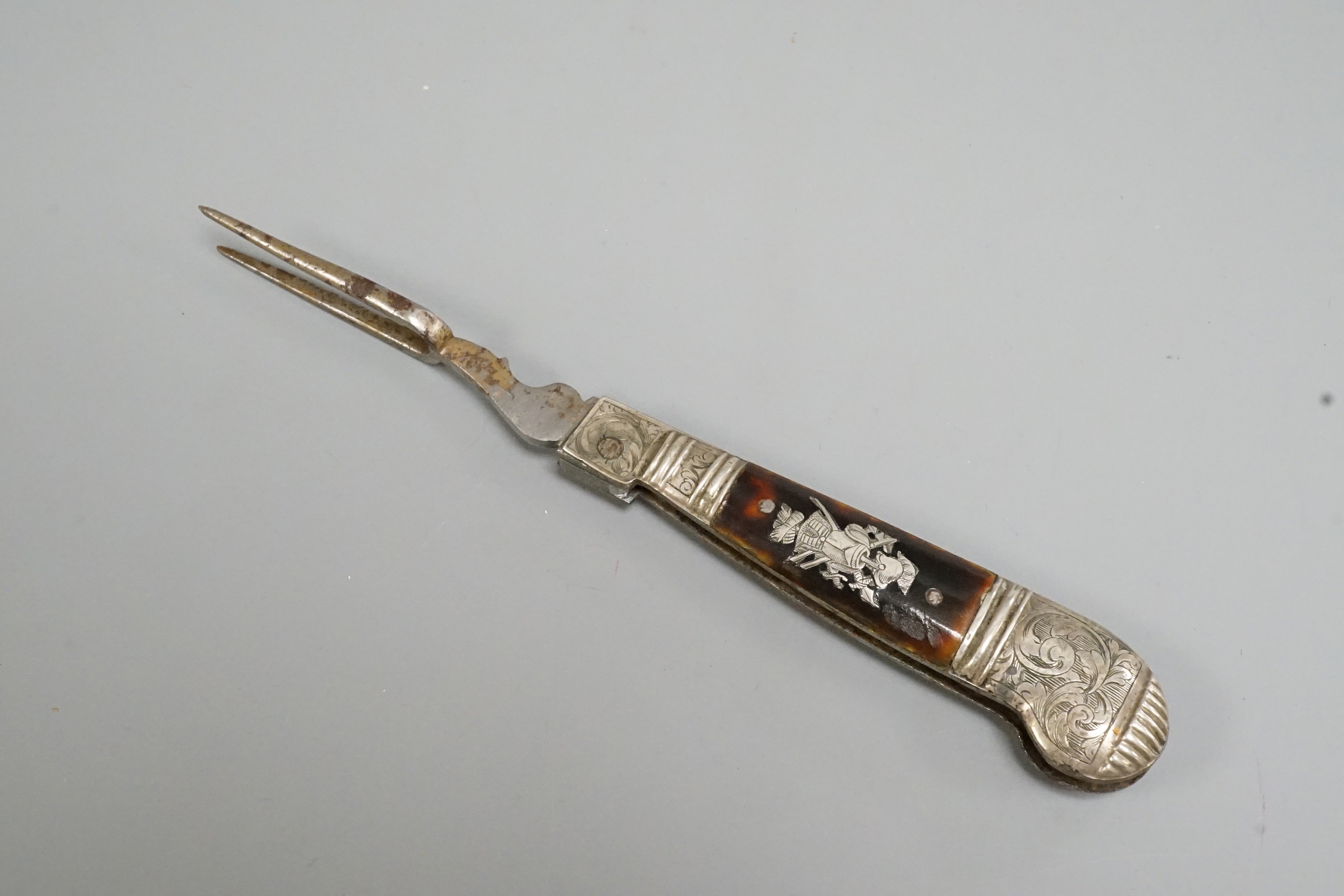 A 17th century white metal and tortoiseshell mounted pistol handled folding fork, 17.4cm.
